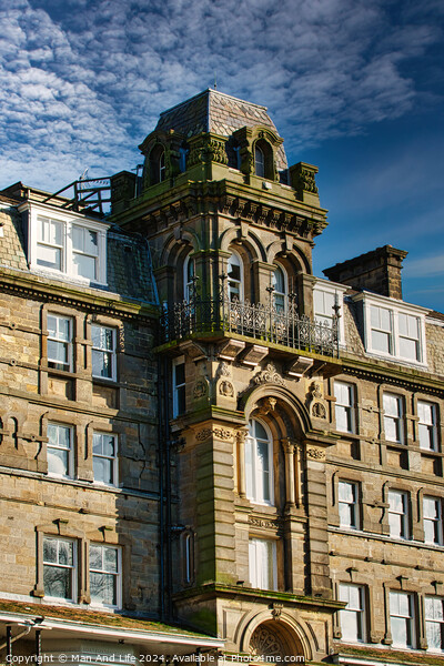 Victorian architecture with ornate details on a historic building against a blue sky with clouds in Harrogate, England. Picture Board by Man And Life