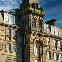 Buy canvas prints of Victorian architecture with ornate details on a historic building against a blue sky with clouds in Harrogate, England. by Man And Life