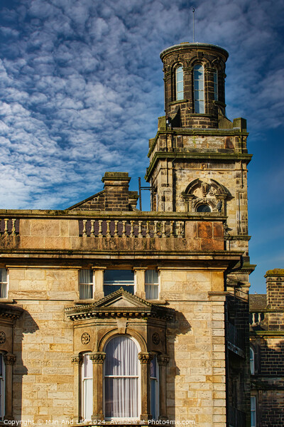 Historic stone building with a tower under a blue sky with textured clouds in Harrogate, England. Picture Board by Man And Life