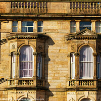 Buy canvas prints of Close-up of a classic sandstone building facade with ornate windows and architectural details in warm sunlight in Harrogate, England. by Man And Life