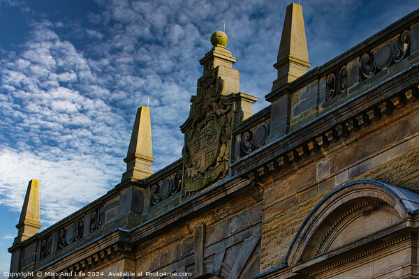 Historic building facade with ornate sculptures against a blue sky with clouds in Harrogate, England. Picture Board by Man And Life