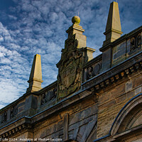 Buy canvas prints of Historic building facade with ornate sculptures against a blue sky with clouds in Harrogate, England. by Man And Life
