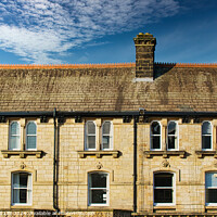 Buy canvas prints of Traditional brick row houses under blue sky with wispy clouds in Harrogate, England. by Man And Life