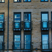Buy canvas prints of Modern apartment building facade with symmetrical windows and balconies, urban architecture background in Harrogate, England. by Man And Life