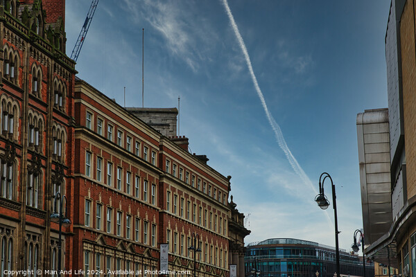 Urban street view with historic buildings under a clear blue sky with contrails in Leeds, UK. Picture Board by Man And Life