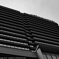 Buy canvas prints of Modern black and white architectural photograph of a high-rise building with a patterned facade against a cloudy sky in Leeds, UK. by Man And Life