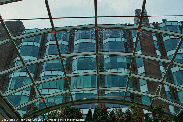 Modern glass building facade viewed through a transparent arched ceiling, showcasing urban architecture in Leeds, UK. Picture Board by Man And Life