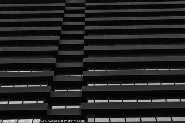 Monochrome image of modern building facade with geometric pattern of windows and ledges, abstract urban background in Leeds, UK. Picture Board by Man And Life