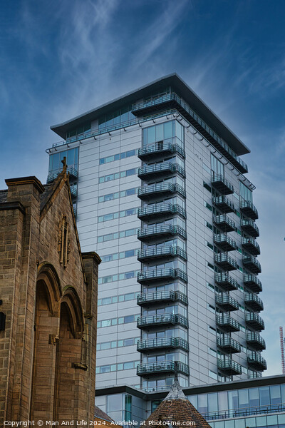 Contrast of old and new architecture with a modern glass skyscraper towering behind a traditional stone church under a clear blue sky in Leeds, UK. Picture Board by Man And Life