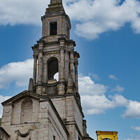 Buy canvas prints of Historic church steeple with clock under a blue sky with clouds in Leeds, UK. by Man And Life
