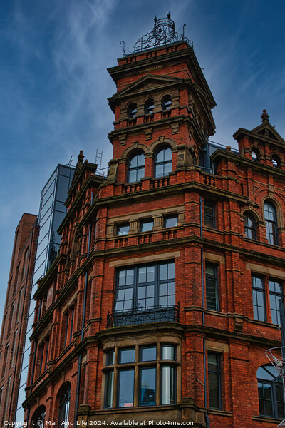 Victorian red brick building with ornate architecture against a dramatic cloudy sky, showcasing a contrast of historical and modern urban design in Leeds, UK. Picture Board by Man And Life