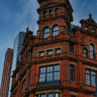 Buy canvas prints of Victorian red brick building with ornate architecture against a dramatic cloudy sky, showcasing a contrast of historical and modern urban design in Leeds, UK. by Man And Life
