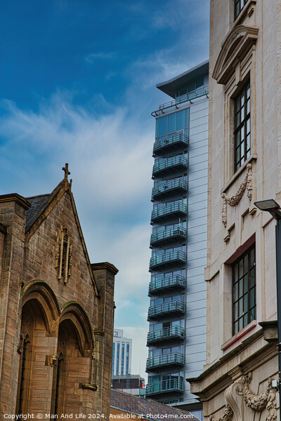 Contrast of old and new architecture with a historic church in the foreground and a modern skyscraper in the background against a blue sky in Leeds, UK. Picture Board by Man And Life