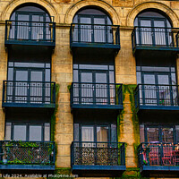 Buy canvas prints of Facade of a vintage building with ornate windows and balconies in Leeds, UK. by Man And Life