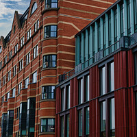 Buy canvas prints of Modern urban architecture with red brick and glass facade against a cloudy sky in Leeds, UK. by Man And Life