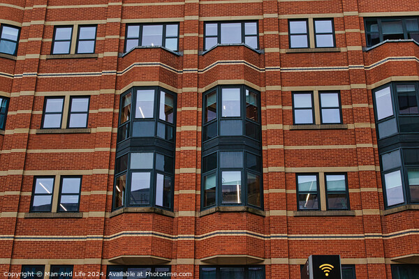 Modern brick building facade with patterned windows and architectural details in Leeds, UK. Picture Board by Man And Life