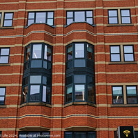 Buy canvas prints of Modern brick building facade with patterned windows and architectural details in Leeds, UK. by Man And Life