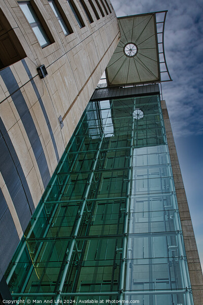 Modern architectural detail with glass facade and clock tower against a blue sky in Leeds, UK. Picture Board by Man And Life