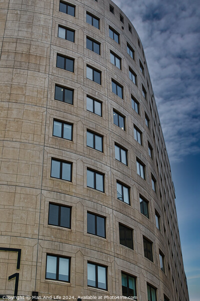 Curved modern office building facade with symmetric windows against a cloudy sky in Leeds, UK. Picture Board by Man And Life