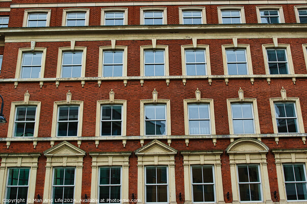Facade of a classic red brick building with symmetrical windows against a clear sky in Leeds, UK. Picture Board by Man And Life
