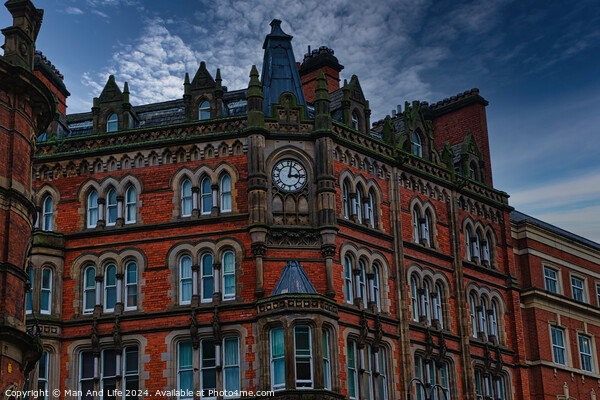 Gothic-style red brick building with clock tower under a moody sky in Leeds, UK. Picture Board by Man And Life