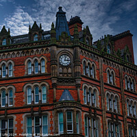 Buy canvas prints of Gothic-style red brick building with clock tower under a moody sky in Leeds, UK. by Man And Life