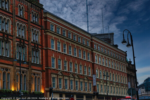 Historic red brick building at dusk with street lamp and dramatic sky in Leeds, UK. Picture Board by Man And Life