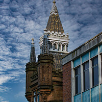 Buy canvas prints of Historic tower with spire against a dramatic cloudy sky, juxtaposed with modern building facade in Leeds, UK. by Man And Life