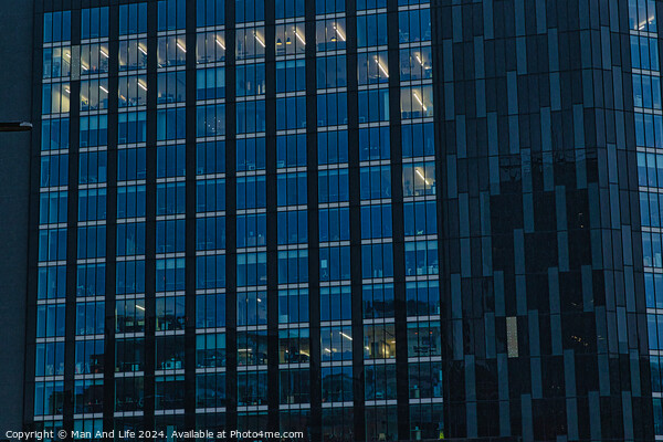Modern office building facade with reflective glass windows at dusk in Leeds, UK. Picture Board by Man And Life