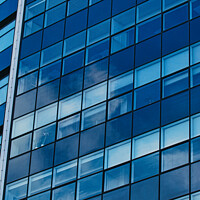 Buy canvas prints of Modern glass building facade reflecting blue sky with clouds, architectural details and textures, urban background in Leeds, UK. by Man And Life
