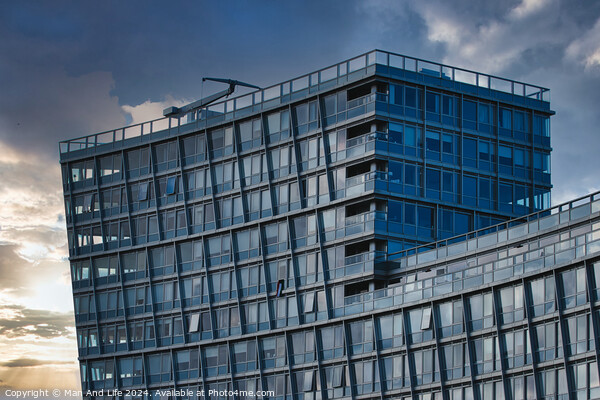 Modern office building facade against a dramatic sunset sky in Liverpool, UK. Picture Board by Man And Life