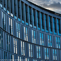 Buy canvas prints of Modern office building facade with reflective glass windows against a cloudy sky at dusk in Liverpool, UK. by Man And Life