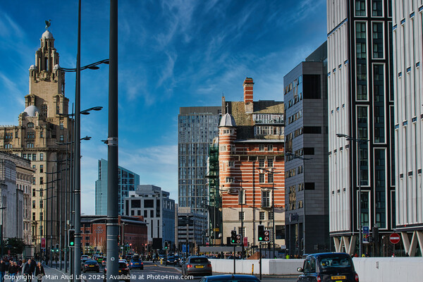Urban cityscape with modern and historic architecture under a clear blue sky in Liverpool, UK. Picture Board by Man And Life