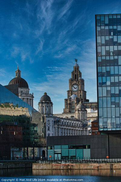 Contrast of old and new architecture with historic buildings and modern glass skyscraper against a blue sky with wispy clouds in Liverpool, UK. Picture Board by Man And Life