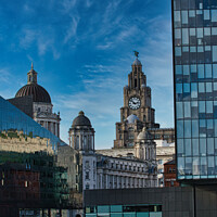 Buy canvas prints of Contrast of old and new architecture with historic buildings and modern glass skyscraper against a blue sky with wispy clouds in Liverpool, UK. by Man And Life