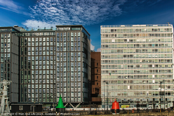 Modern office buildings with reflective glass facades under a blue sky with scattered clouds in Liverpool, UK. Picture Board by Man And Life