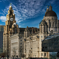 Buy canvas prints of Liverpool's iconic waterfront buildings under a blue sky with wispy clouds. by Man And Life