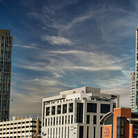 Buy canvas prints of Modern cityscape with skyscrapers against a blue sky with wispy clouds in Liverpool, UK. by Man And Life