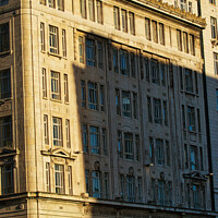 Buy canvas prints of Sunlight casting shadows on a classic urban building facade during golden hour, highlighting architectural details in Liverpool, UK. by Man And Life