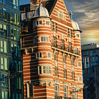 Buy canvas prints of Traditional red brick building juxtaposed with modern glass facade architecture at sunset in Liverpool, UK. by Man And Life