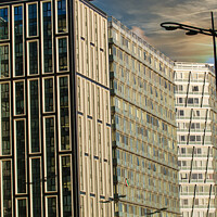 Buy canvas prints of Modern urban architecture with reflective glass facade and contrasting building designs under a blue sky with clouds in Liverpool, UK. by Man And Life