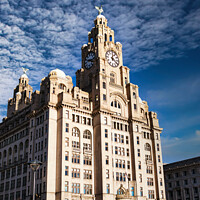 Buy canvas prints of Historic clock tower building against a blue sky with clouds in Liverpool, UK. by Man And Life