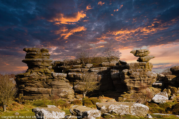 Dramatic sky at sunset over rugged rock formations in a serene landscape at Brimham Rocks, in North Yorkshire Picture Board by Man And Life