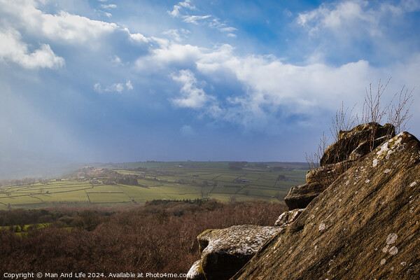 Scenic view from a rocky outcrop overlooking a lush valley under a dramatic cloudy sky at Brimham Rocks, in North Yorkshire Picture Board by Man And Life