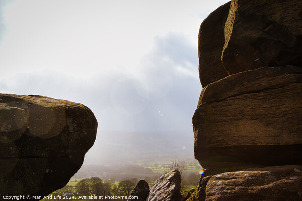 Scenic view of a landscape through rock formations under a cloudy sky at Brimham Rocks, in North Yorkshire Picture Board by Man And Life