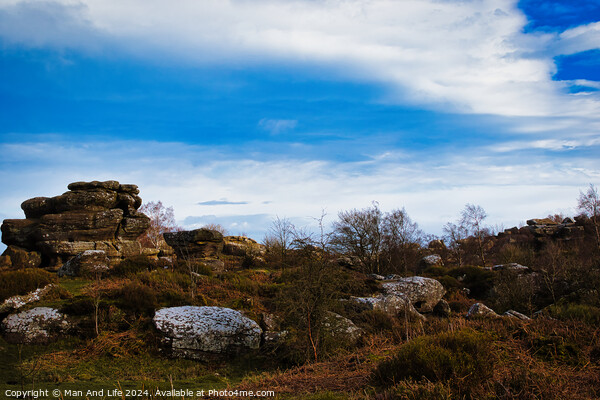 Scenic view of rock formations under a dramatic blue sky with clouds at Brimham Rocks, in North Yorkshire Picture Board by Man And Life