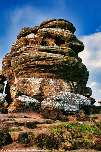 Majestic rock formation under blue sky with clouds, showcasing natural erosion and geological layers at Brimham Rocks, in North Yorkshire Picture Board by Man And Life