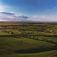 Buy canvas prints of Scenic aerial view of lush green fields under a dramatic sky at dusk, showcasing the beauty of rural landscapes in North Yorkshire. by Man And Life