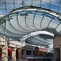 Buy canvas prints of Modern glass ceiling architecture at a shopping mall with blue sky and clouds visible through the transparent structure in Leeds, UK. by Man And Life