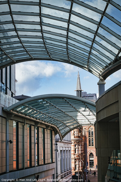 Modern glass canopy over a pedestrian walkway with historic architecture in the background on a sunny day in Leeds, UK. Picture Board by Man And Life